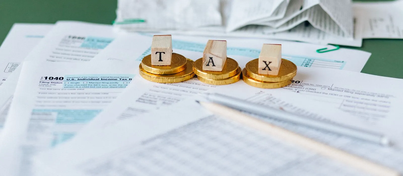 Tax forms and paperwork on a desk, accountant web design by Designs by Delia