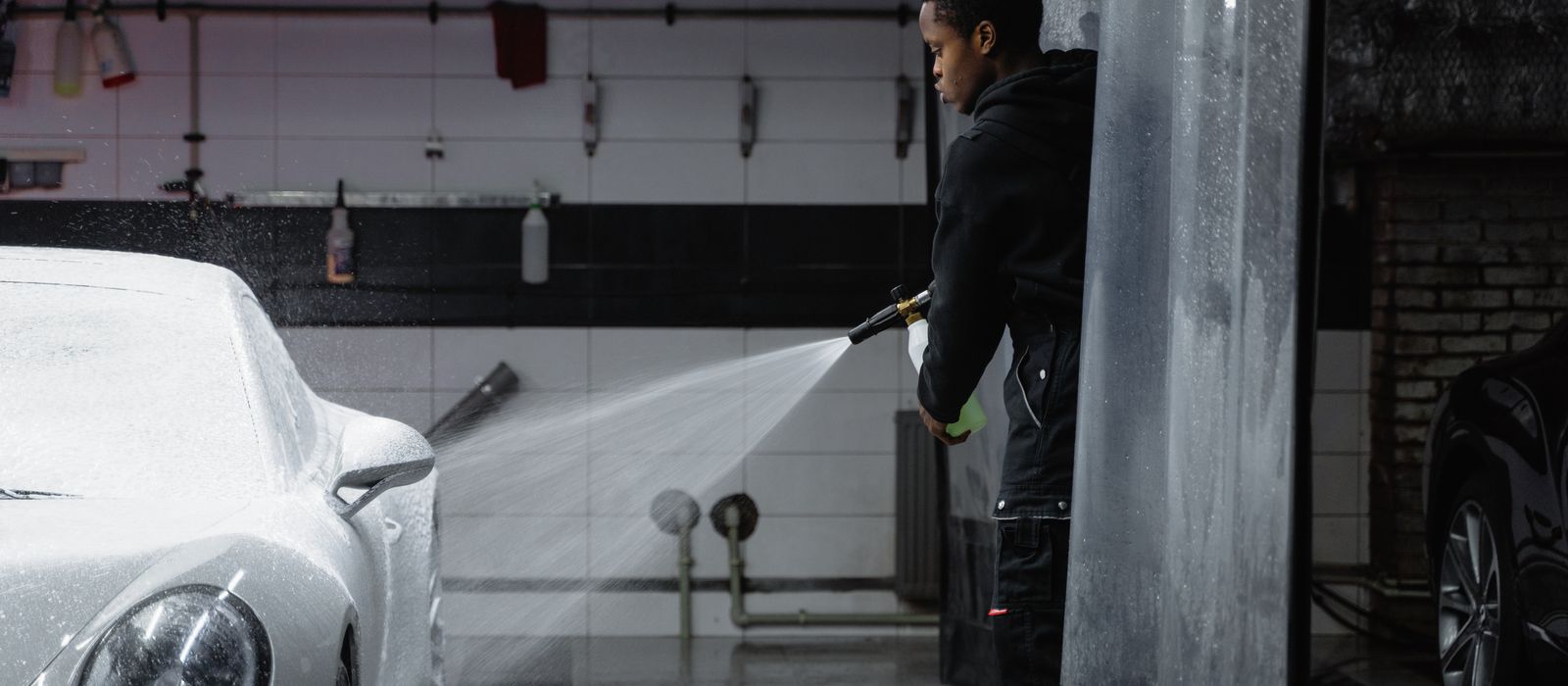 A car being washed with a pressure sprayer, car wash web design by Designs by Delia