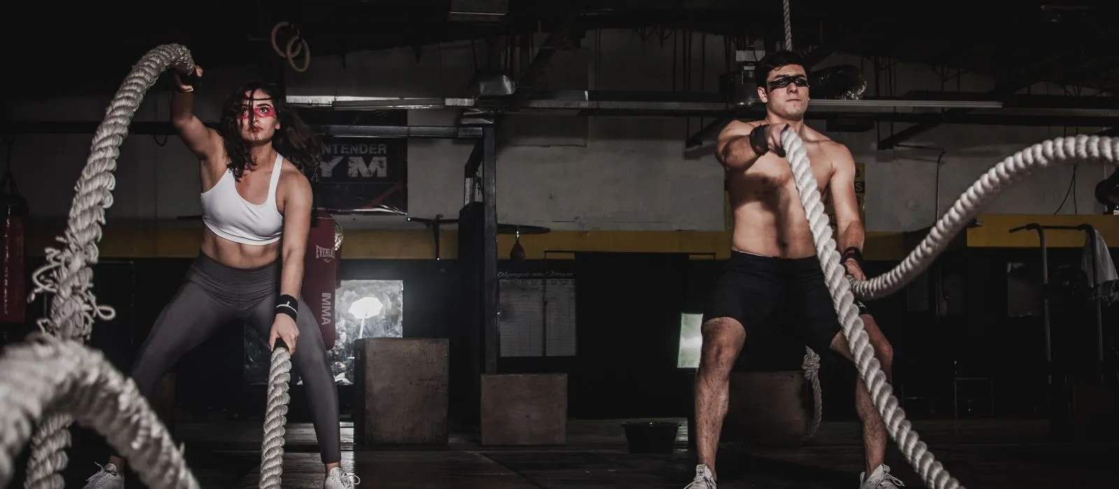Athletes training with battle ropes in a gym, gym web design by Designs by Delia