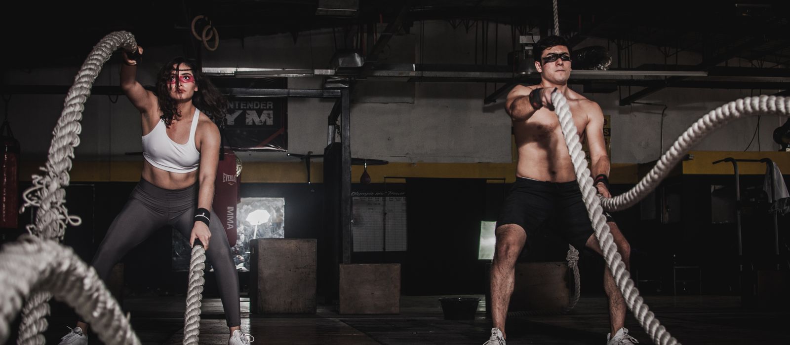 Athletes training with battle ropes in a gym, gym web design by Designs by Delia
