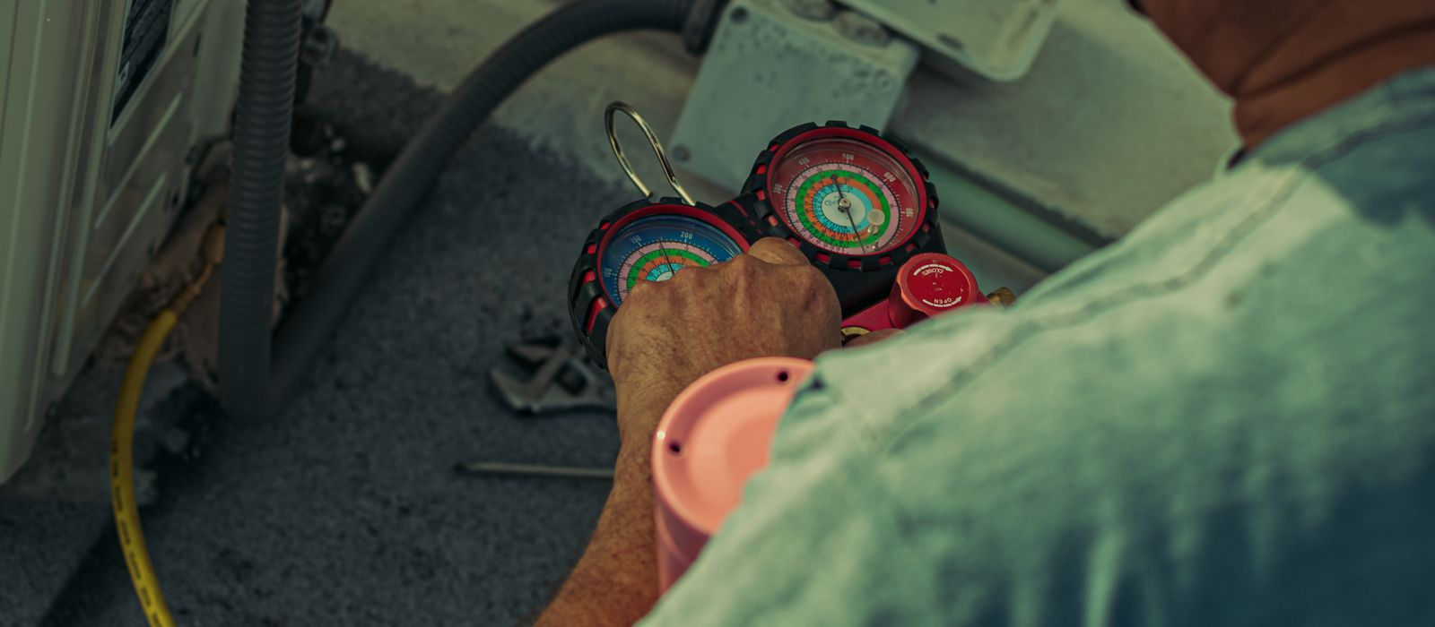 An HVAC technician servicing an air conditioning unit, HVAC web design by Designs by Delia