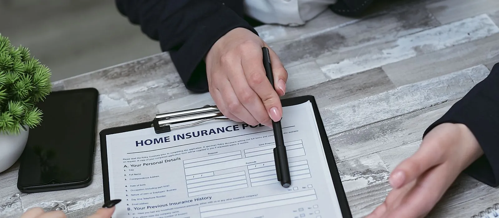 An insurance agent reviewing a policy with a client, insurance agency web design by Designs by Delia