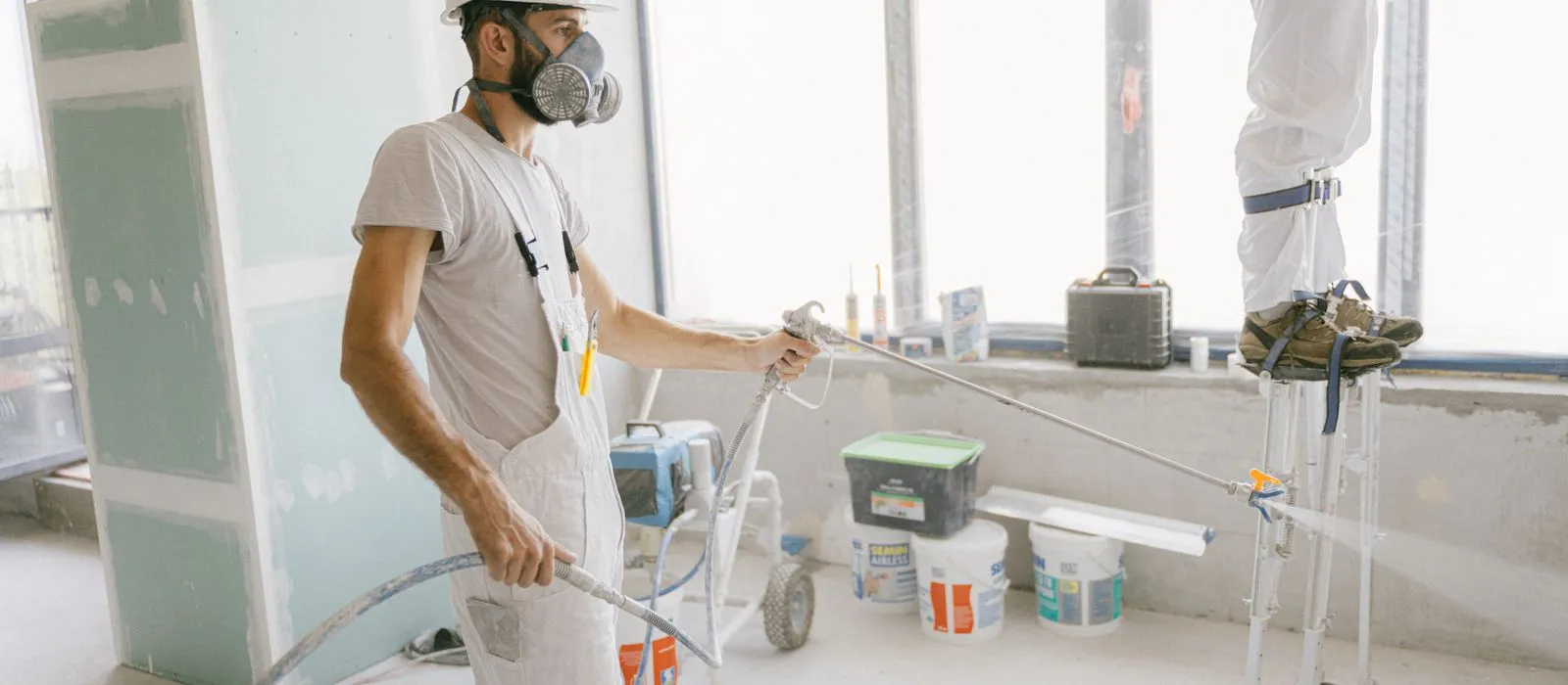 A painter preparing an interior room for painting, painting contractor web design by Designs by Delia