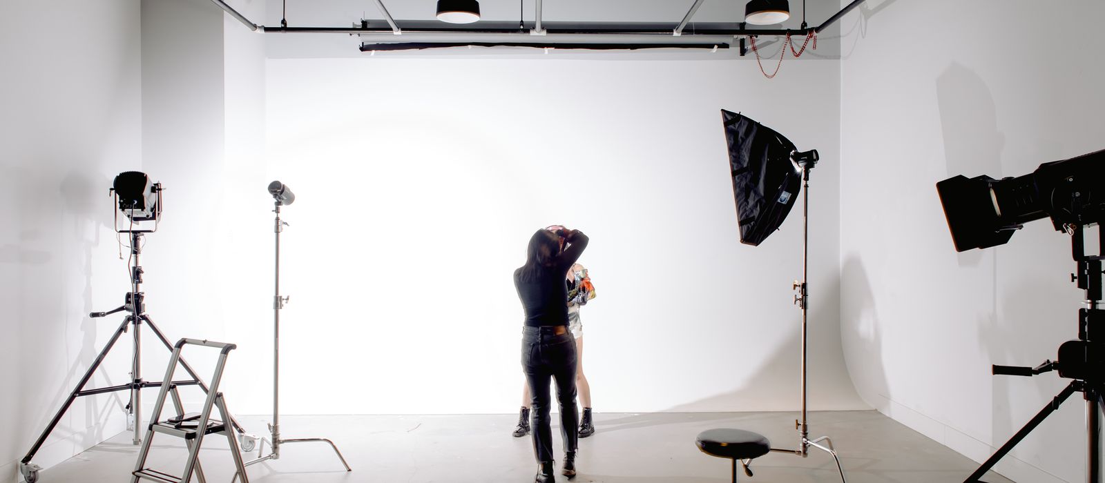 A photographer working in a lighting studio, photographer web design by Designs by Delia