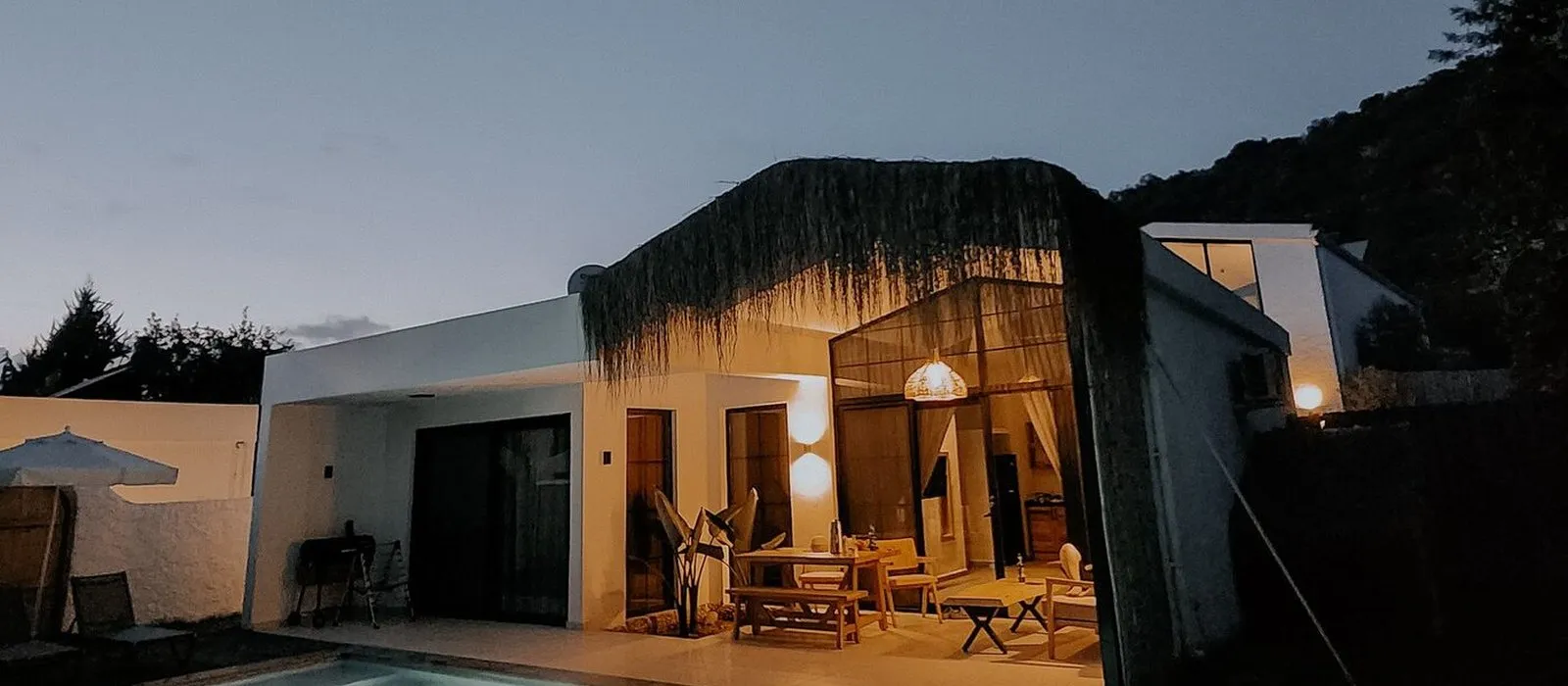 A modern luxury home at dusk, real estate web design by Designs by Delia