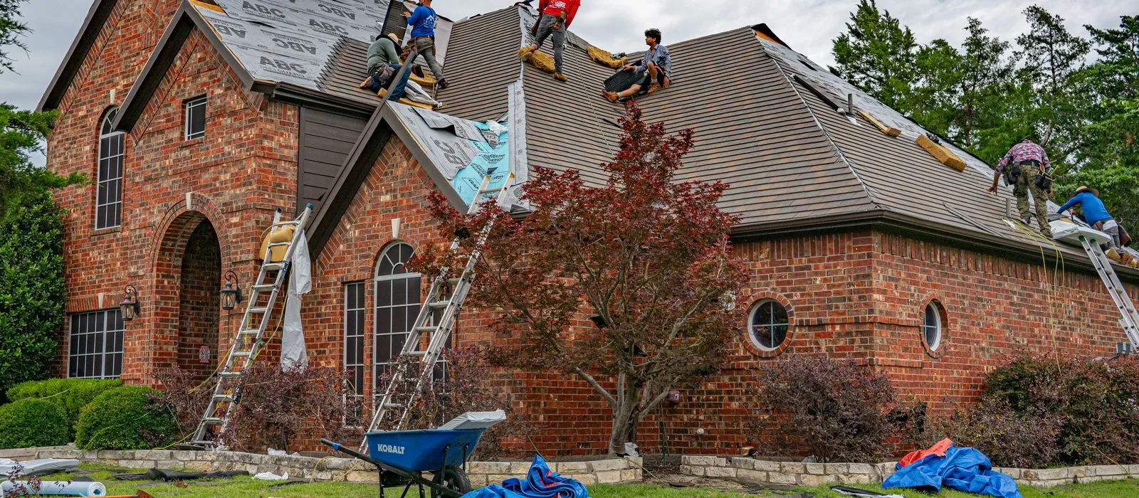 A crew working on a residential roof, roofing web design by Designs by Delia