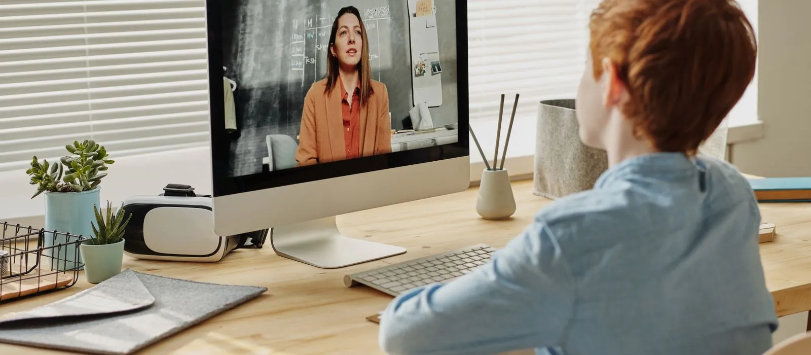 A student in an online tutoring session at a desk, tutoring web design by Designs by Delia