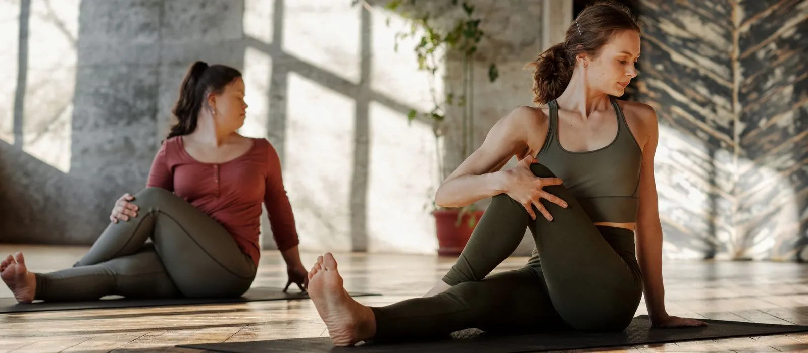 A yoga class practicing in a bright studio, yoga studio web design by Designs by Delia