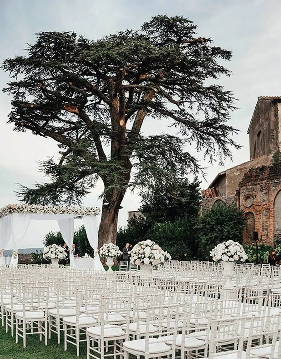 Garden ceremony with rows of white chairs