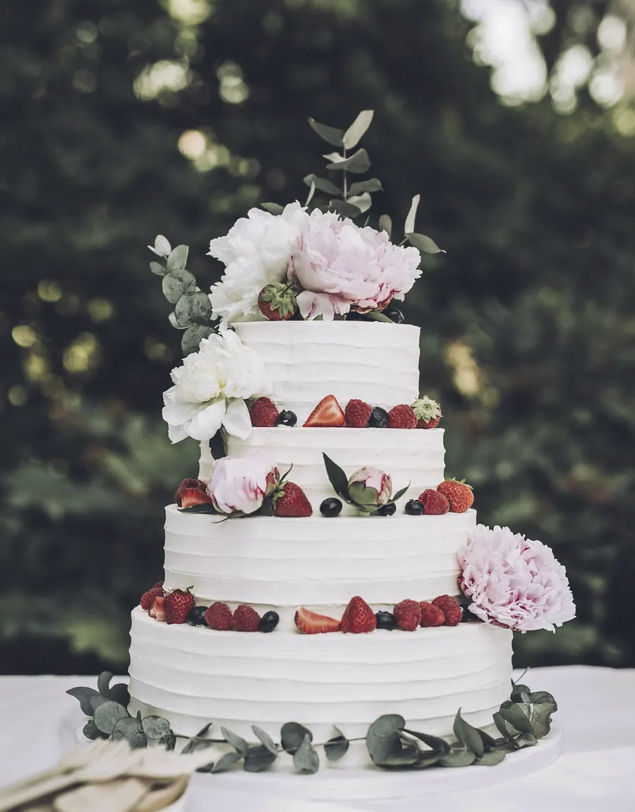 Tiered cake with strawberries and flowers