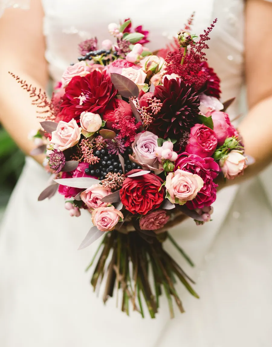 Bride holding a bouquet of garden roses