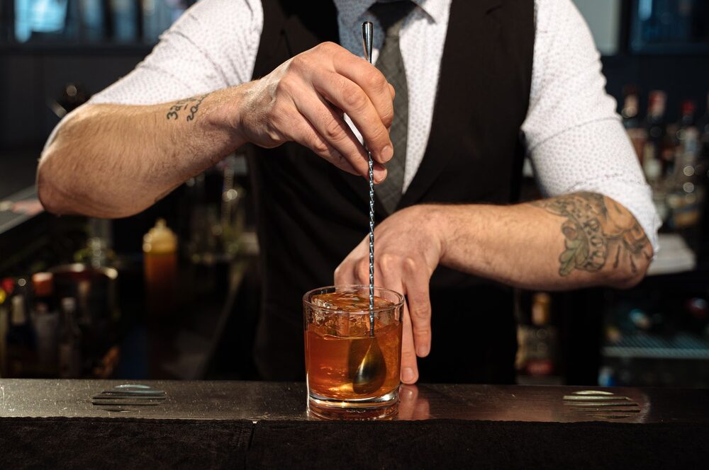 A bartender stirring a drink