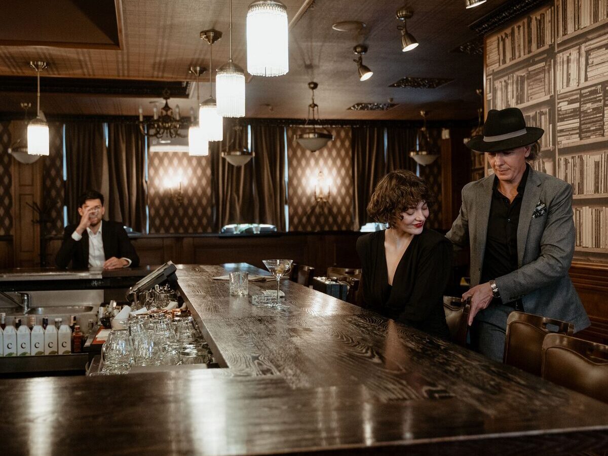 Two guests at a dimly lit bar