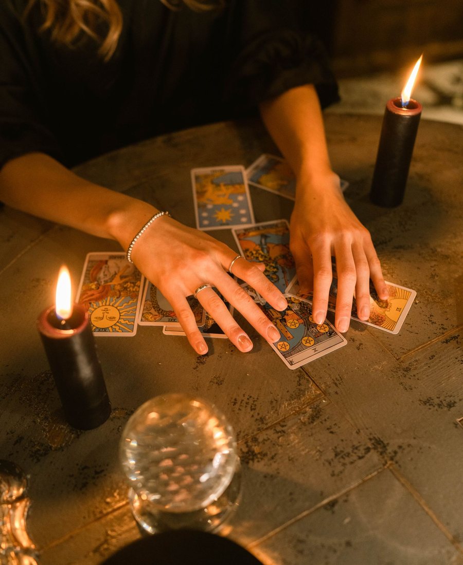 A tarot reading in progress by candlelight