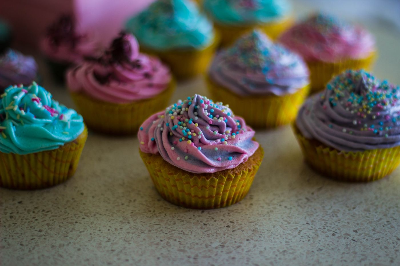 Colorful frosted cupcakes with sprinkles