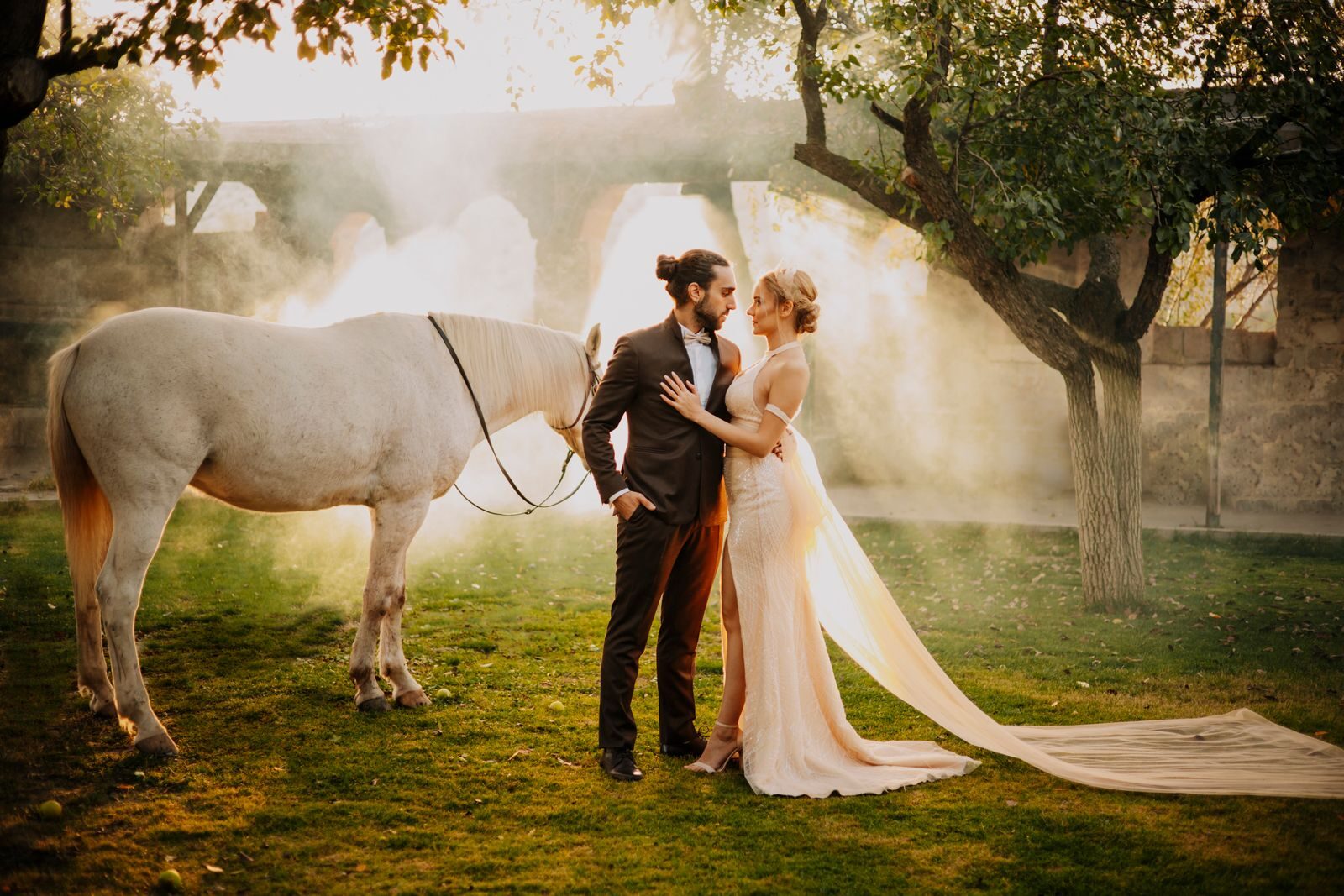 Couple with a horse in golden evening light