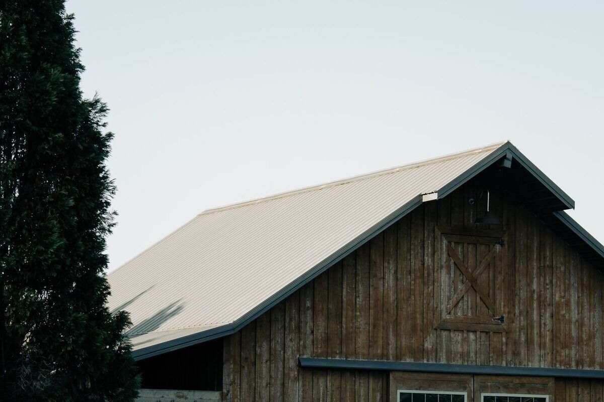 Historic wooden barn among trees