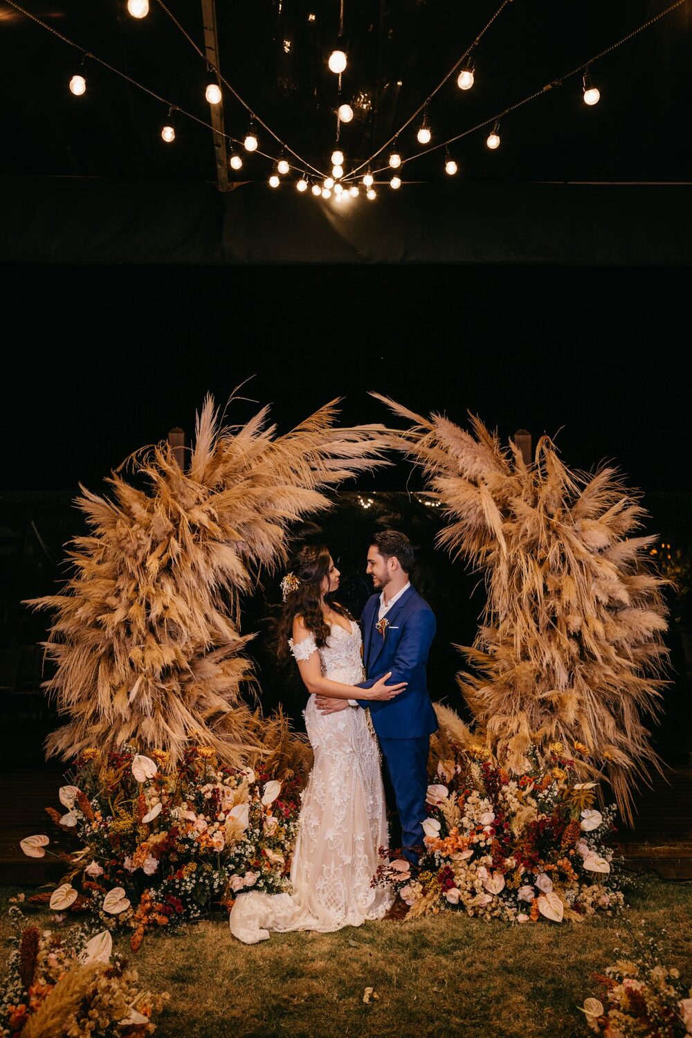 Floral arch lit at night